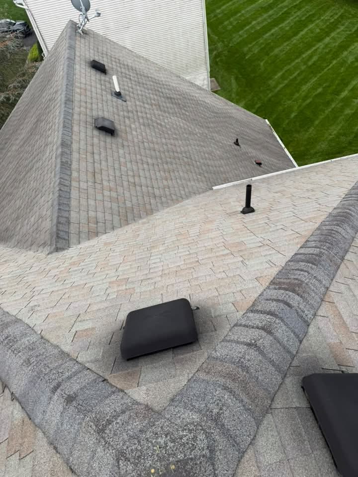 Completed shingle roof with hips and vents