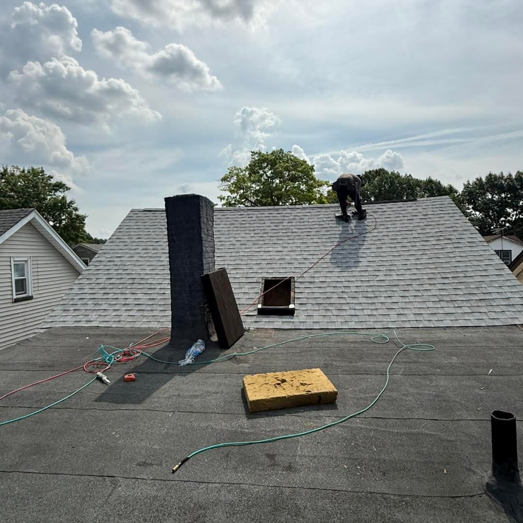 JKL Roofing crew working on a roof ridge